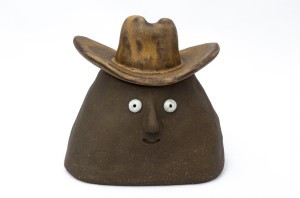 Smiling stoneware container with cowboy hat