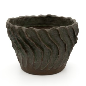 Dark brown stoneware planter with undulating vertical ribs