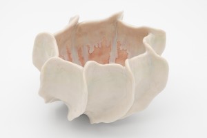 Porcelain hand-pinched vessel with peach-colored drippy glaze on interior